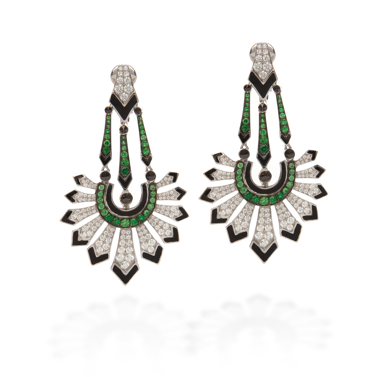 A pair of Art Deco style drop earrings featuring green emerald-cut stones, black enamel, and pavé-set clear stones on a white background.
